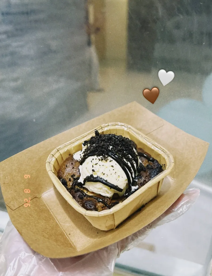 Acai bowl with dark cookie drizzle and a heart sticker