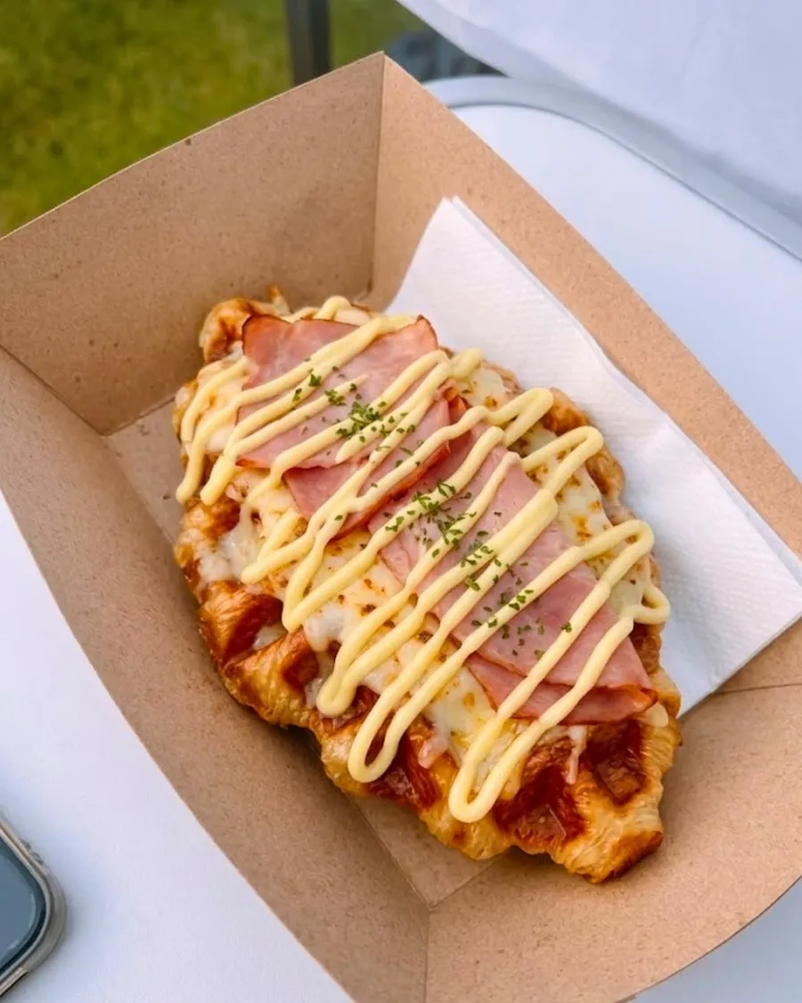 Savoury croffle topped with ham, melted cheese and a mayo drizzle